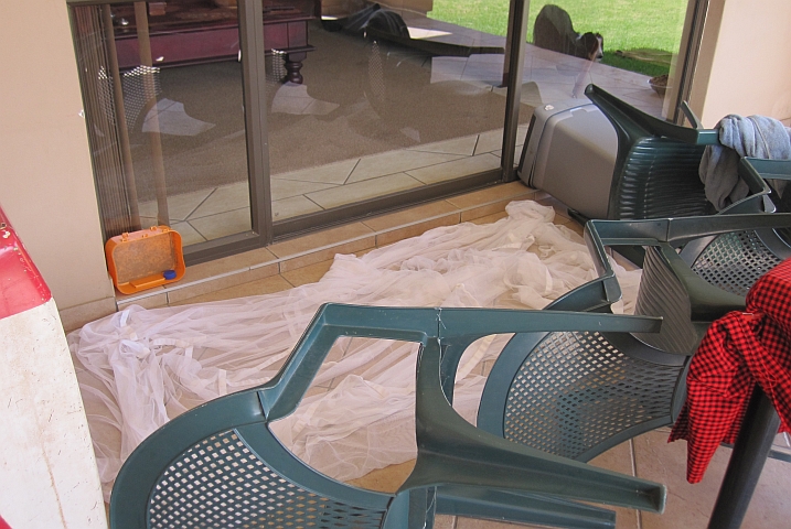 Der Zaun aus Stühlen um das Moskitonetz