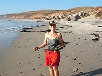 Isabella sammelt flache Steine am Strand von Strandfontein